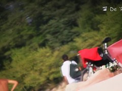 Beach voyeur man enjoys the view of topless female tits