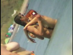 Beach spy cam catches a readhead girl running into the water