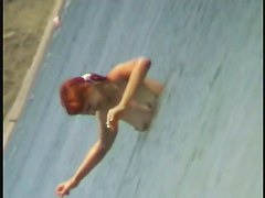 Beach spy cam catches a readhead girl running into the water