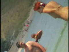 Beach spy cam catches a readhead girl running into the water