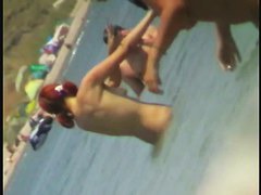 Beach spy cam catches a readhead girl running into the water