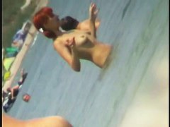 Beach spy cam catches a readhead girl running into the water