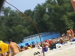 Nudist beach voyeur vid with a hot brunette milf
