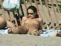 Tempting women sunbathing in a nude beach video