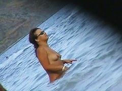 Nude beach voyeur scenes with amateurs bathing in the sea
