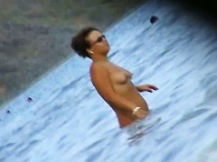 Nude beach voyeur scenes with amateurs bathing in the sea