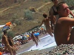 Guys are filming some girls on the beach