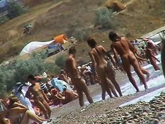 Guys are filming some girls on the beach