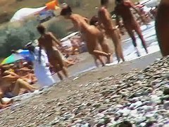 Guys are filming some girls on the beach