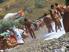 Guys are filming some girls on the beach