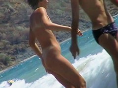 Guys are filming some girls on the beach