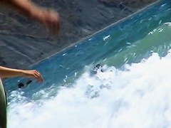 Guys are filming some girls on the beach