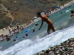 Guys are filming some girls on the beach