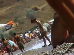 Guys are filming some girls on the beach