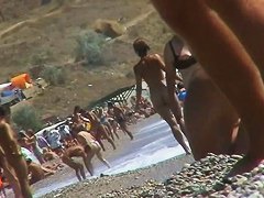 Guys are filming some girls on the beach