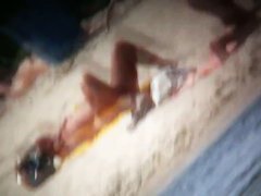 A voyeur is hunting for beautiful women on a nudist beach