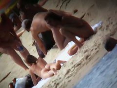 A voyeur is hunting for beautiful women on a nudist beach