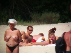 Huge boobed sexy ladies lie on the beach and relaxing