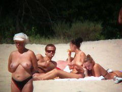 Huge boobed sexy ladies lie on the beach and relaxing