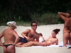 Huge boobed sexy ladies lie on the beach and relaxing