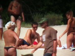 Huge boobed sexy ladies lie on the beach and relaxing