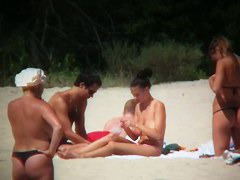 Huge boobed sexy ladies lie on the beach and relaxing