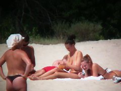 Huge boobed sexy ladies lie on the beach and relaxing