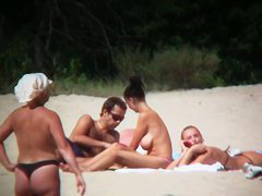 Huge boobed sexy ladies lie on the beach and relaxing