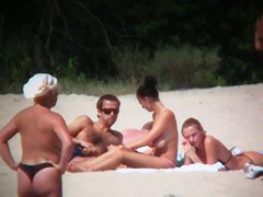 Huge boobed sexy ladies lie on the beach and relaxing