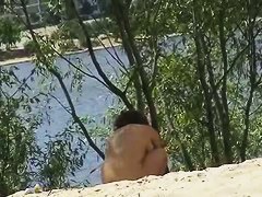 Mature lady with nice natural tits naked on beach spy cam