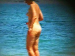 Hot mature beach nudist strips of her clothes and gets wet