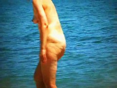 Hot mature beach nudist strips of her clothes and gets wet