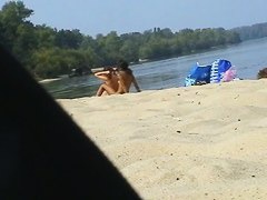 Cute lesbian teens enjoying sunbathing at nudist beach