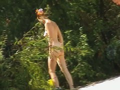 Couple taking sunbaths and walking nakes on the beach
