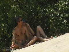 Couple taking sunbaths and walking nakes on the beach
