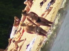 Mature women with big butts taking sunbaths on the beach