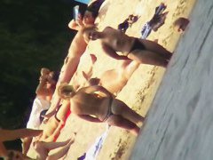 Mature women with big butts taking sunbaths on the beach