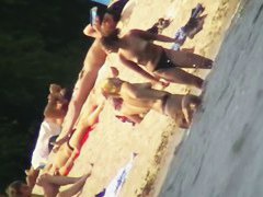 Mature women with big butts taking sunbaths on the beach