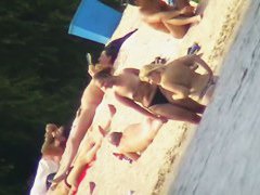 Mature women with big butts taking sunbaths on the beach