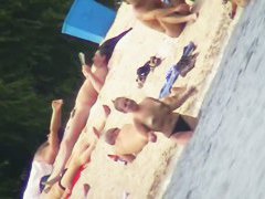 Mature women with big butts taking sunbaths on the beach