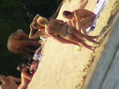 Mature women with big butts taking sunbaths on the beach