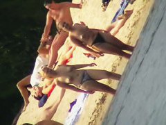 Mature women with big butts taking sunbaths on the beach