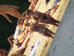 Mature women with big butts taking sunbaths on the beach