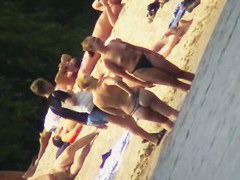 Mature women with big butts taking sunbaths on the beach