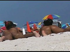Amazing beach voyeur vid of two nudist girls and their wet pussies