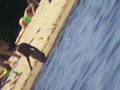 Cute brunette with black thong in the beach video