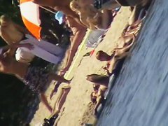 Cute brunette with black thong in the beach video