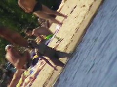 Cute brunette with black thong in the beach video