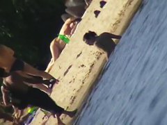 Cute brunette with black thong in the beach video