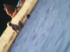 Cute brunette with black thong in the beach video